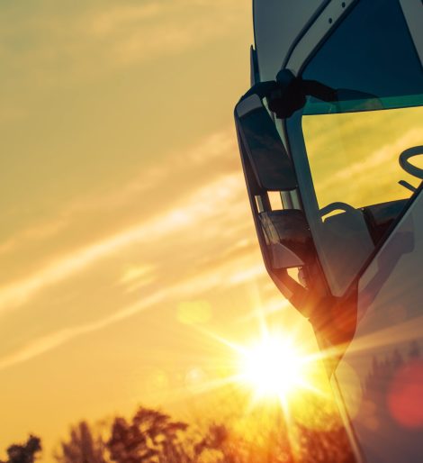 Semi Truck Transport Concept Photo. Semi Truck Cabin and the Sunlight.